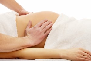 Pregnant woman having a massage on her belly
