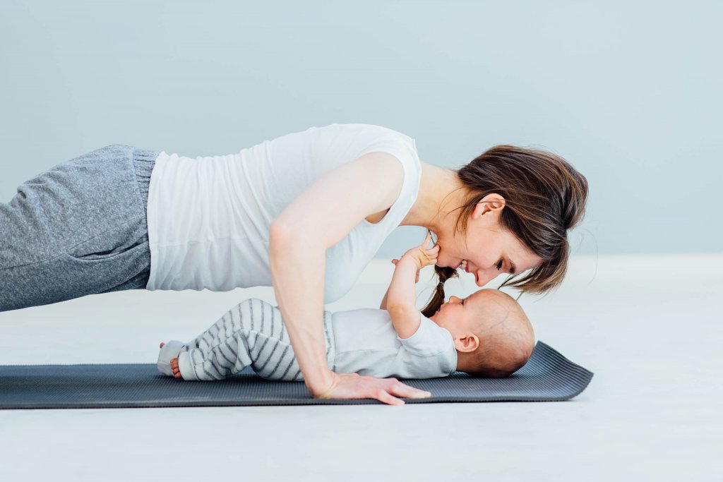 Mom doing yoga with her baby