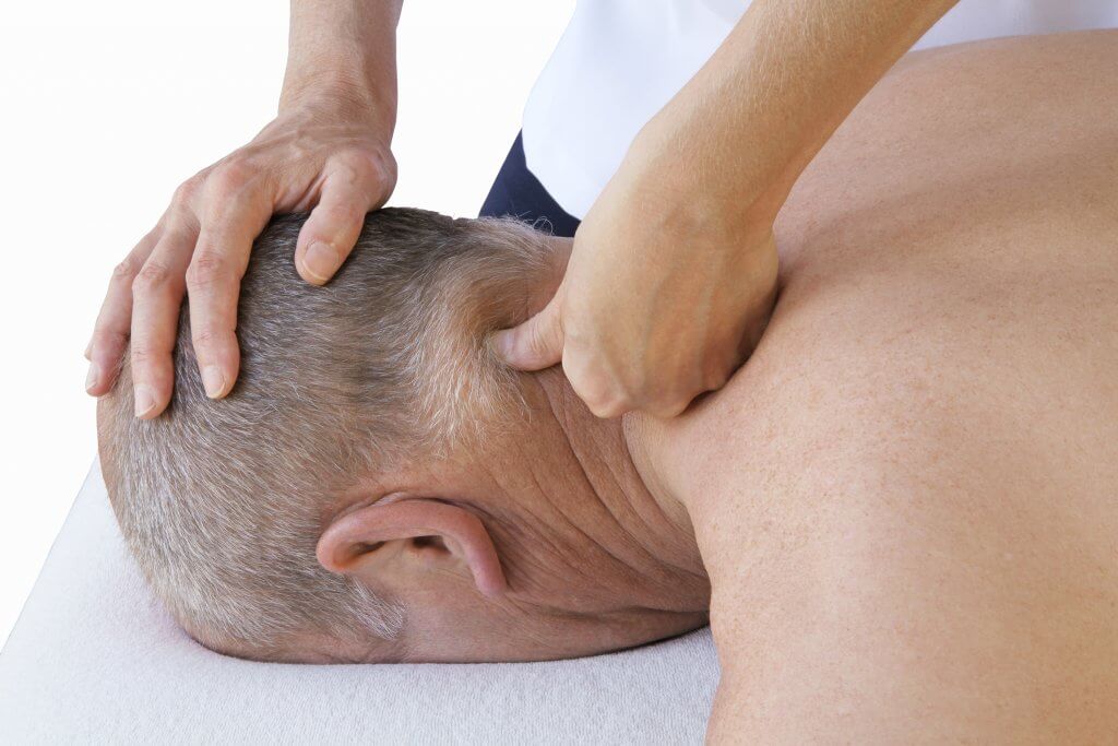 man receiving neuromuscular therapy session