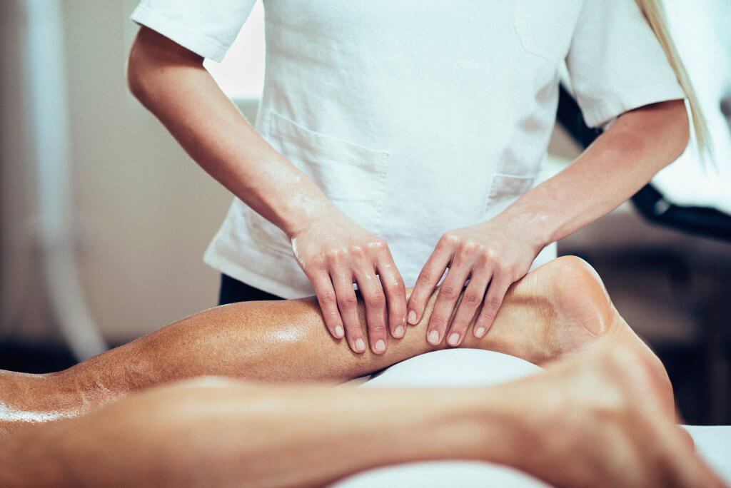 massage therapist performing a sports massage in a spa