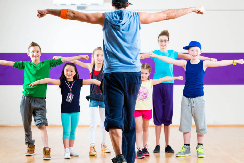 teacher giving youth physical fitness class