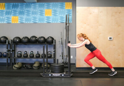 Health Coach and Personal Trainer Shannon Dolan Pushing the Sled