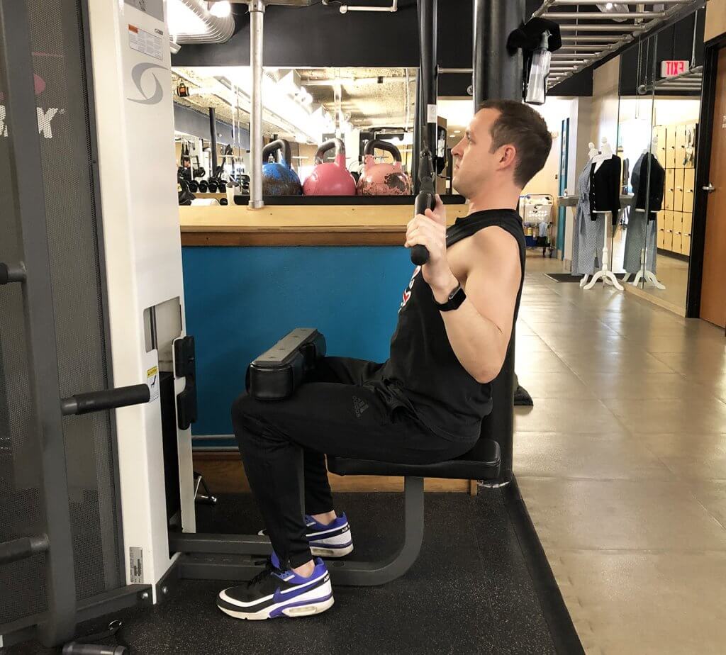 Fifth Step of Lat Pull Down Exercise with Keith Kohanek - Keep shoulders down and back, while slowly pulling bar down to the chest. 