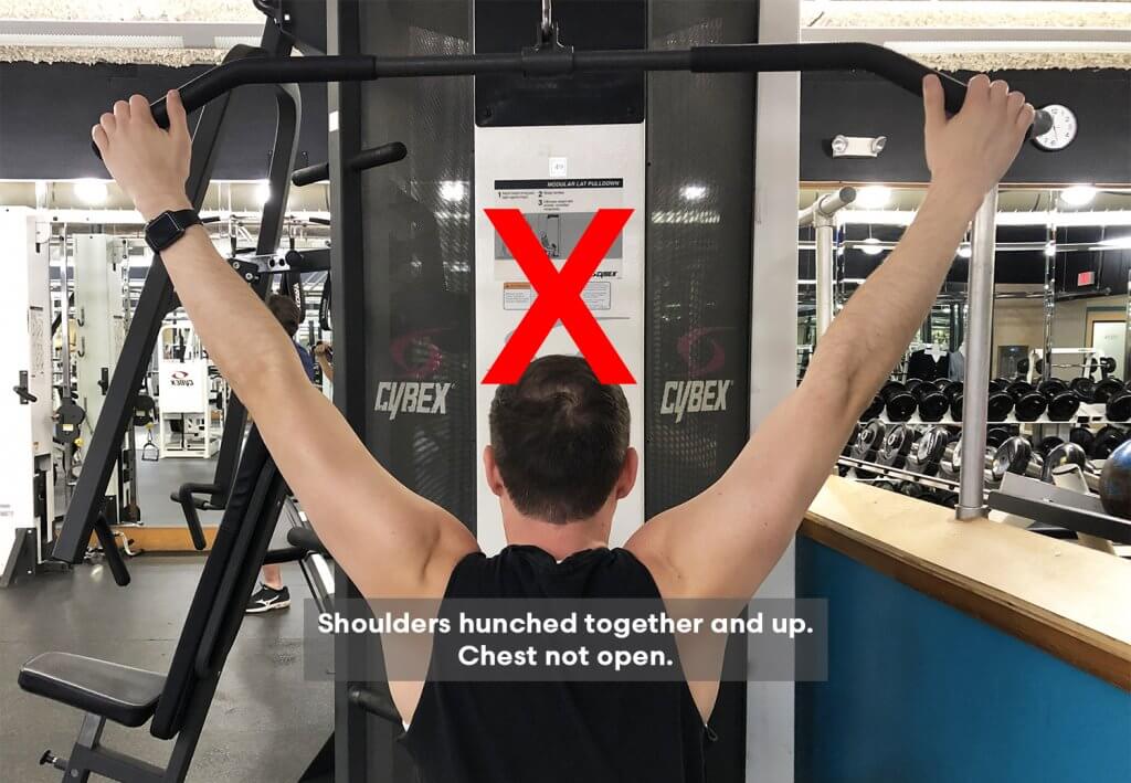 Bad Variation of Fourth Step of Lat Pull Down Exercise with Keith Kohanek - Shoulders are hunched together and pulled up to the ears. 