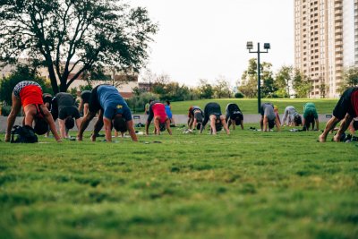 People doing Downward Dog at Free Day of Yoga at Waterloo Greenway's Moody Amphitheater