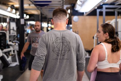 Image of a man and woman walking down the hallway with their back towards the camera