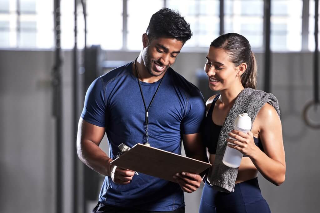 Photo of a male Health Coach and his female client reviewing a clipboard for Find-a-Fix tool blog