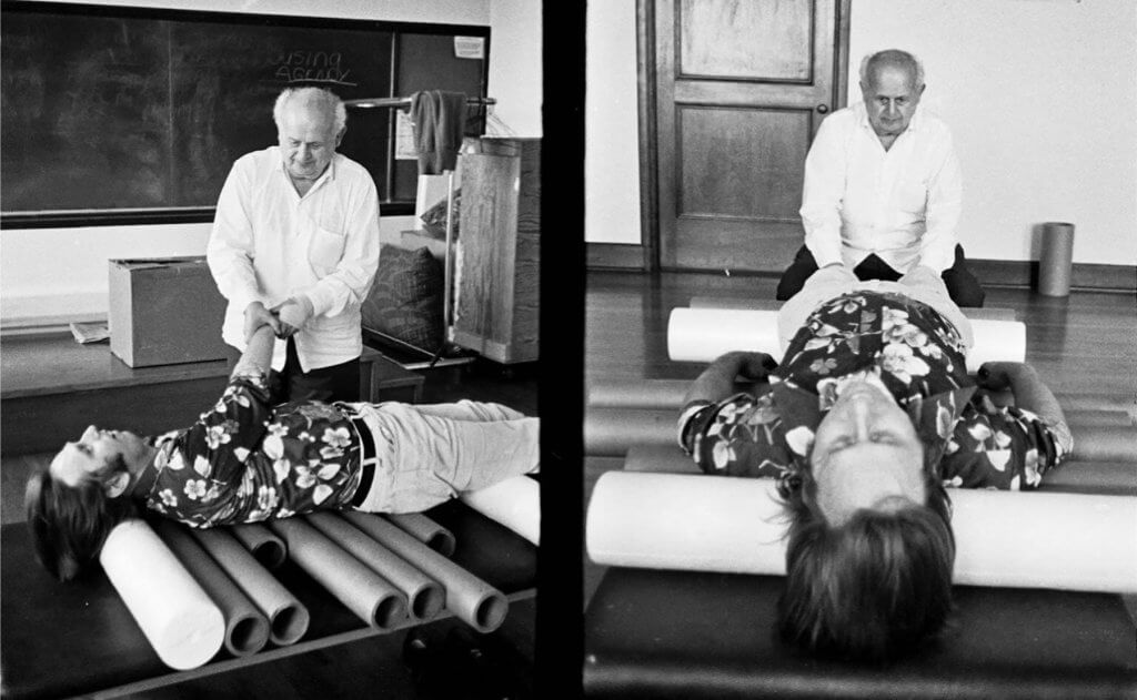 Moshe Feldenkrais with a client using foam rollers