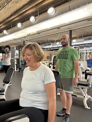 Cindy Lin training with Personal Trainer Alon Kay on gym equipment